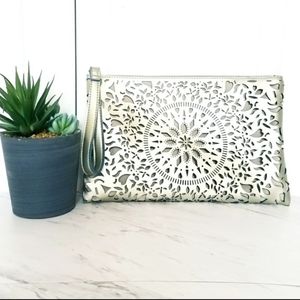 REPOSH Carlos Santana clutch in metallic champagne